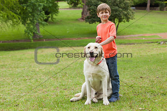 Portrait of a boy with pet dog at park
