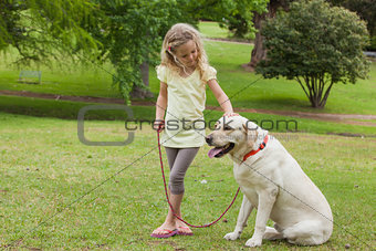 Young girl with pet dog at park