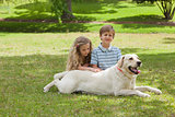 Portrait of kids with pet dog at park