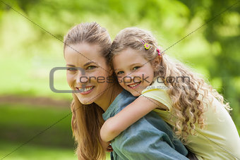 Side view of a woman carrying girl at park