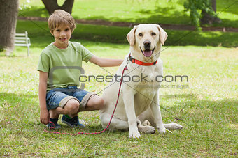 Full length of a boy with pet dog at park