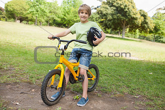 Smiling boy riding bicycle at park