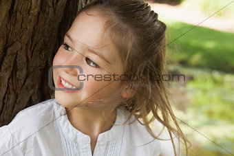 Smiling young girl looking away in park