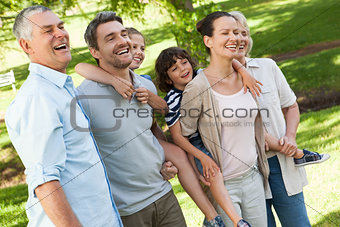 Cheerful extended family standing at park