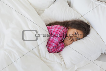 Portrait of a young girl resting in bed
