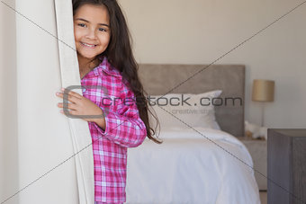 Portrait of a young smiling girl in bedroom