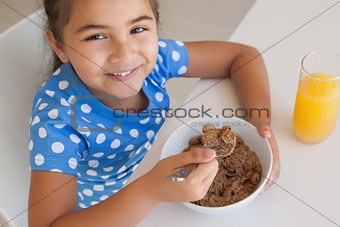 Portrait of a young girl having breakfast