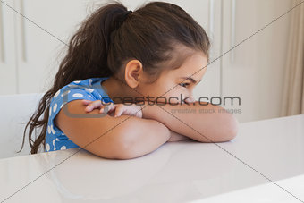 Close-up of a relaxed girl sitting at table