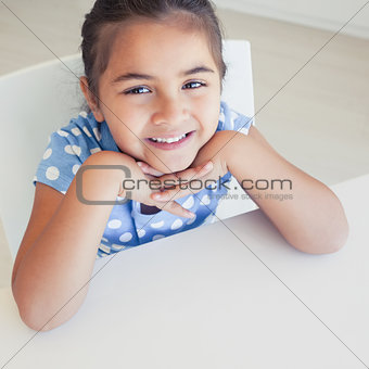 Close-up of a smiling girl at table