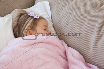 High angle view of a girl sleeping on sofa