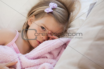 Close-up portrait of a cute girl resting on sofa