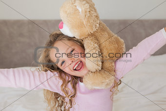 Young happy girl with stuffed toy