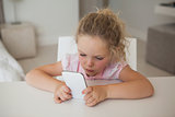 Concentrated young girl text messaging