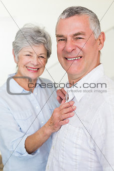 Cheerful retired couple looking at camera