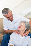 Man giving his senior wife a shoulder rub