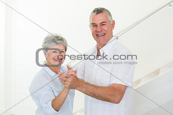 Happy senior couple dancing together