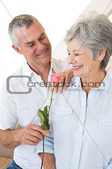 Senior man offering a rose to his partner