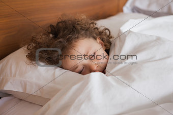 Close-up of a cute girl sleeping in bed
