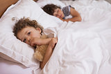 Young girl and boy sleeping in bed