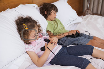 Asleep siblings while playing video games in bedroom