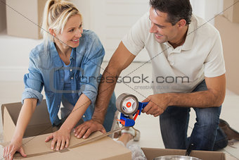 Portrait of a smiling couple packing boxes
