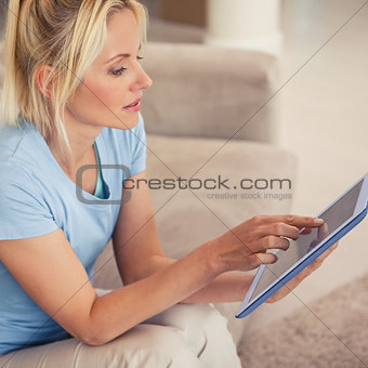 Young woman using digital tablet in living room