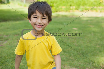 Portrait of a cheerful boy at park