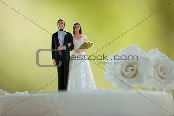 Close-up of figurine couple on wedding cake