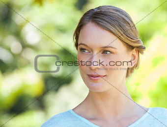 Thoughtful young woman looking away in park