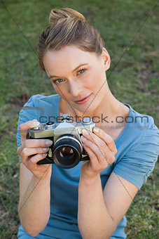 Portrait of a beautiful female photographer at park