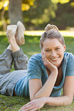 Beautiful relaxed woman lying on grass at park