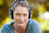 Close-up of beautiful woman enjoying music in park