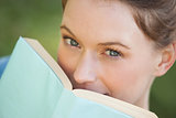 Extreme close-up portrait of beautiful woman with book