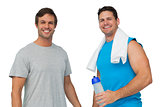 Portrait of two fit young men with water bottle and towel