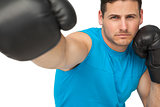 Close-up of a determined male boxer focused on training