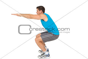Side view of a fit young man doing stretching exercise