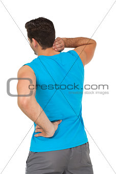 Rear view of man in sportswear suffering from neck ache