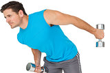Fit young man exercising with dumbbells