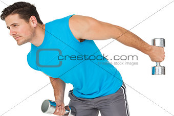 Fit young man exercising with dumbbells