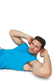 Side view portrait of a young man doing abdominal crunches