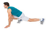 Side view of a fit man doing stretching exercise
