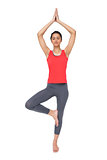 Full length of a fit woman standing in tree pose