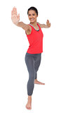 Full length of a sporty woman stretching hands