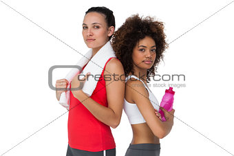 Fit women standing with waterbottle and towel