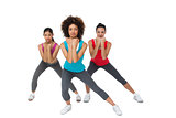 Full length portrait of women doing power fitness exercise