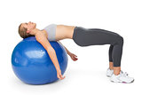 Fit young woman exercising with fitness ball