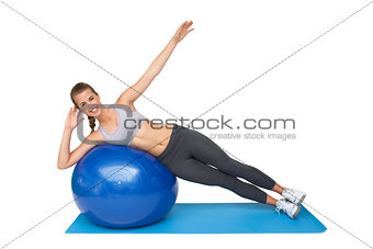 Portrait of a fit woman stretching on fitness ball