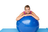 Portrait of a fit smiling woman with fitness ball