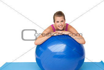 Portrait of a fit smiling woman with fitness ball