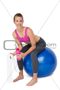 Portrait of a fit woman sitting on exercise ball